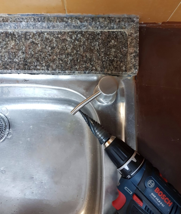 adding soap dispenser to a stainless sink